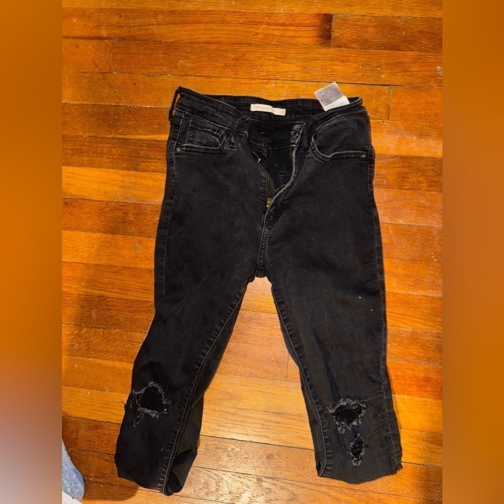 Black Levi’s size 28 ripped on knees